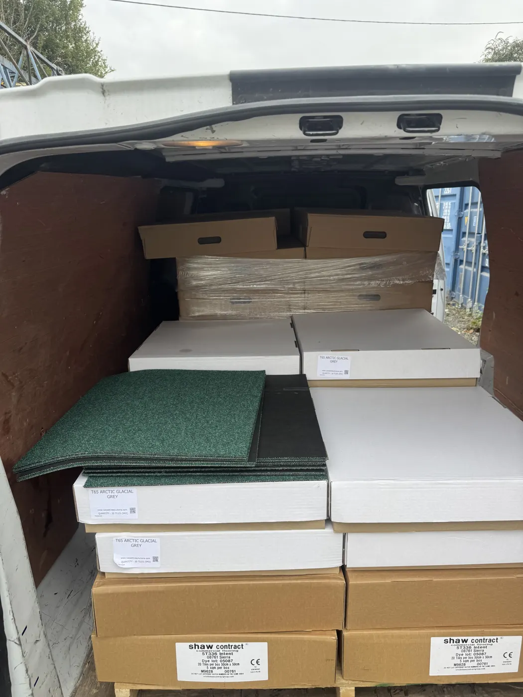 Stack of grey striped used carpet tiles