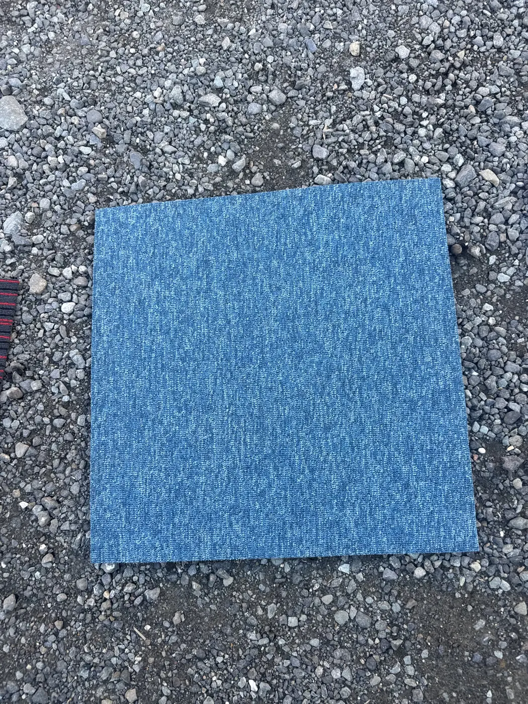 Close-up of grey linear-pattern carpet tile