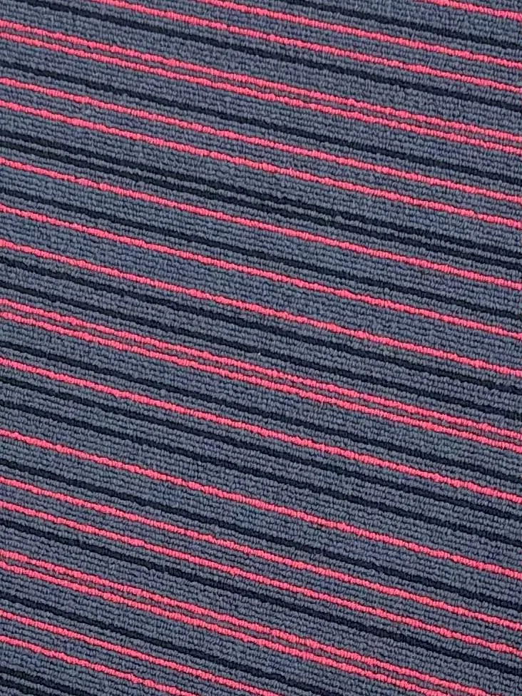 Close-up of rust orange patterned carpet tile